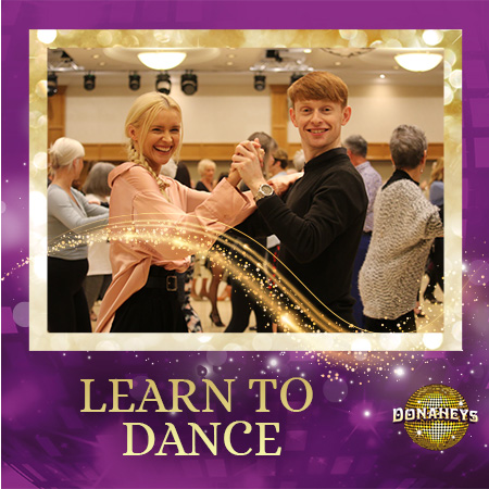 Promotional image of a smiling couple dancing in a dance class, with others in the background and 'LEARN TO DANCE' text at the bottom.