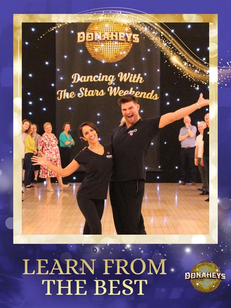 Promo image of a couple ballroom dancing on a stage, with spectators; banner reads 'Dancing With The Stars Weekends'.